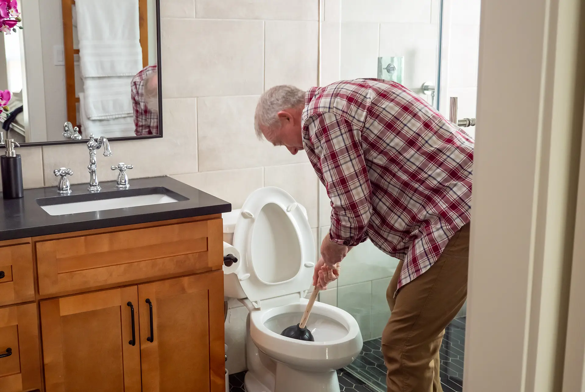 Homeowner Fixing a Clogged Drain