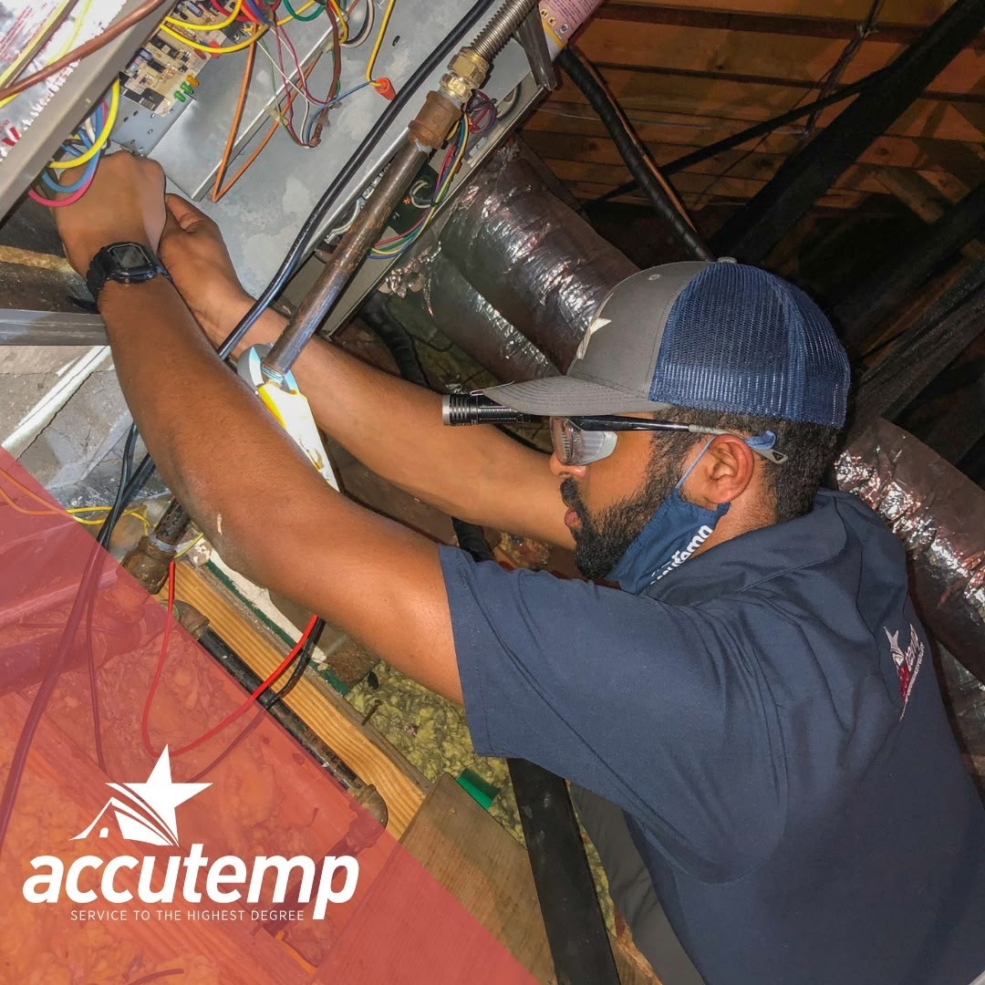 AccuTemp Technician Fixing a Furnace